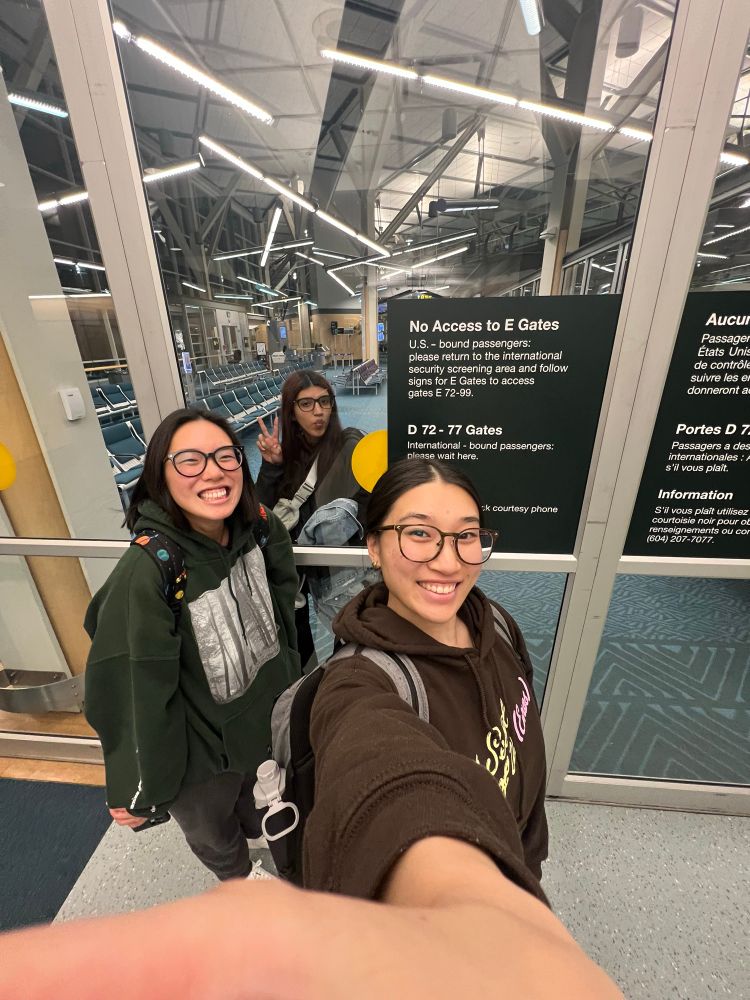 0.5 selfie of me, brianna, and Jazzy at the airport. Me and Brianna are on one side of a window while Jazzy is on the other side. 