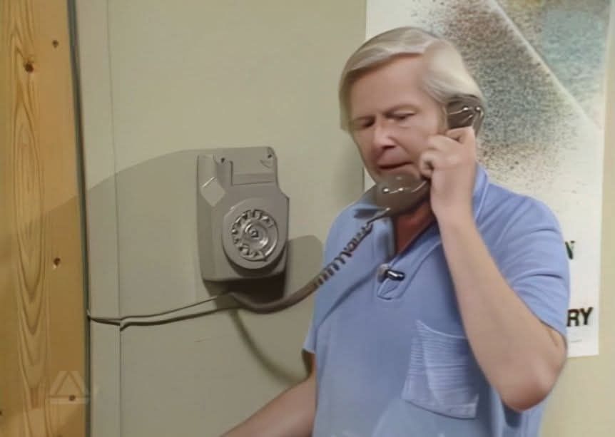 Tony Hart on the phone. He looks like a man from the 70s, even though this was probably 1985.