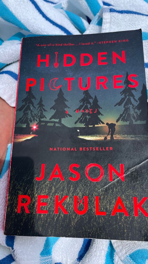 In red print over a picture of someone burying something in the woods at dusk.  "A one-of-a-kind thriller... I loved it." -STEPHEN KING 
HIDDEN PICTURES

NATIONAL BESTSELLER
JASON RENULAK
