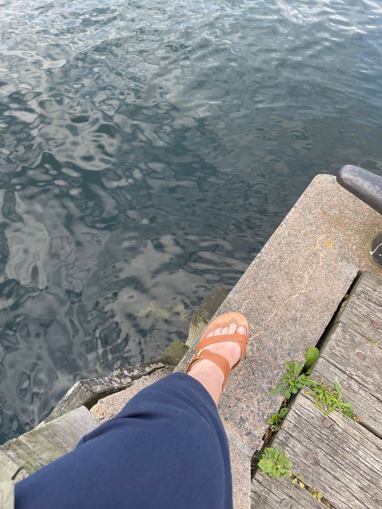 Sandalled foot dangling over the Atlantic 