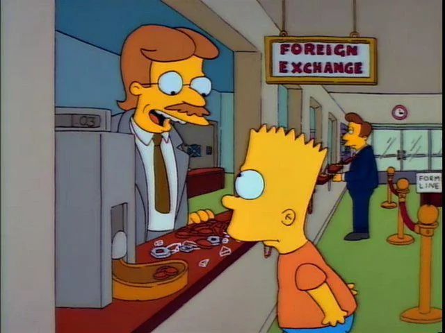 A screenshot from the Good Decade of the Simpsons, in which Bart exchanges various foreign coins for what comes out to three US cents. A mustached man in glasses behind the counter says, uncaptioned, "Let the good times roll."
