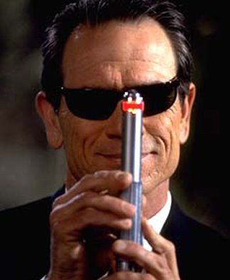 Tommy Lee Jones from Men In Black pointing the red amnesia device directly at the camera
