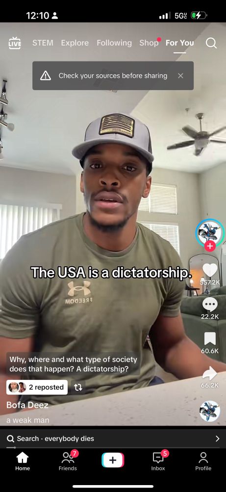 Screenshot of Bofa Deez talking on TikTok. On top of the screen are the words “The USA is a dictatorship.” A warning at the top says “Check your sources before sharing”. 