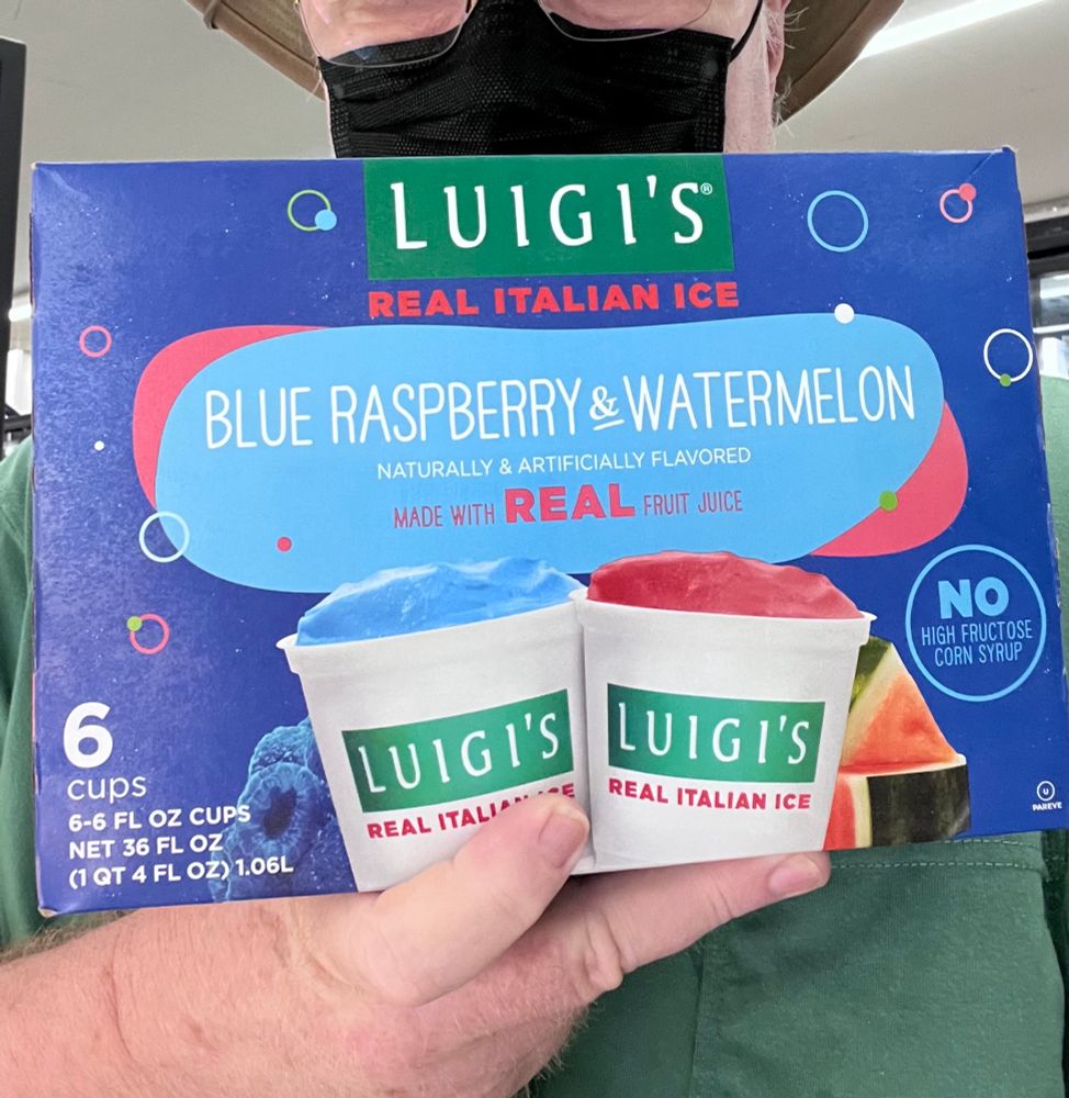 Man holding a box of Luigi’s Italian Ices. 