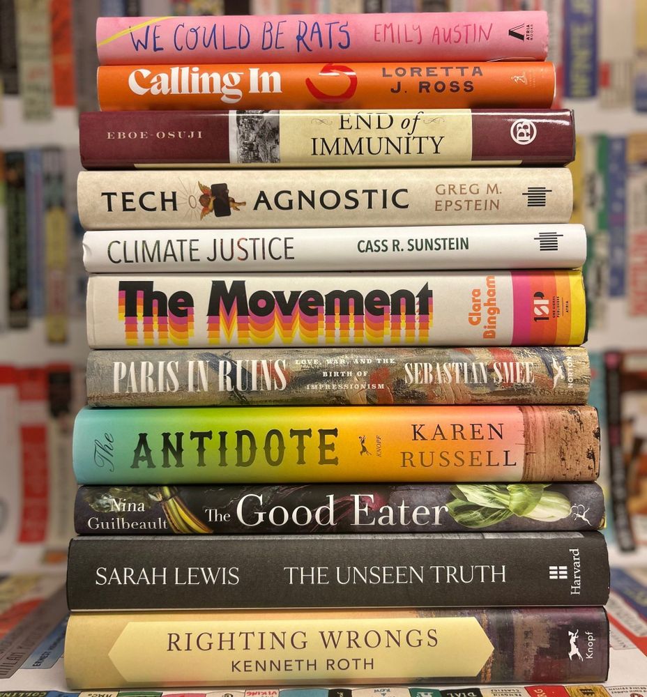 A stack of books with a background featuring illustrated books. The stack of books (all of which were event books from Cambridge Public Library co-sponsored events) features the following titles:
- We Could Be Rats by Emily Austin
- Calling In by Loretta J. Ross
- End of Immunity by Chile Eboe-Osuji 
- Tech Agnostic by Greg M. Epstein
- Climate Justice by Cass R. Sunstein
- The Movement by Clara Bingham
- Paris in Ruins by Sebastian Smee
- The Antidote by Karen Russell
- The Good Eater by Nina Guilbeault
- The Unseen Truth by Sarah Lewis
- Righting Wrongs by Kenneth Roth
