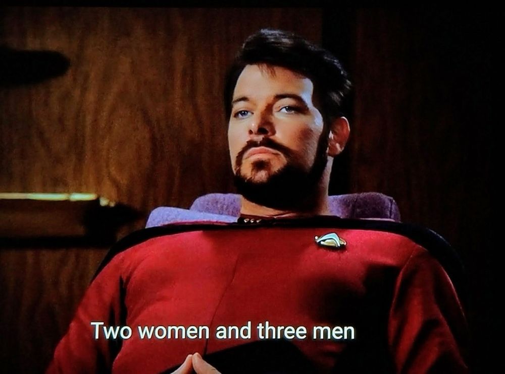 A picture of bearded Commander Riker from Star Trek Next Generation looking contemplative with a caption that says Two Women and three men.
