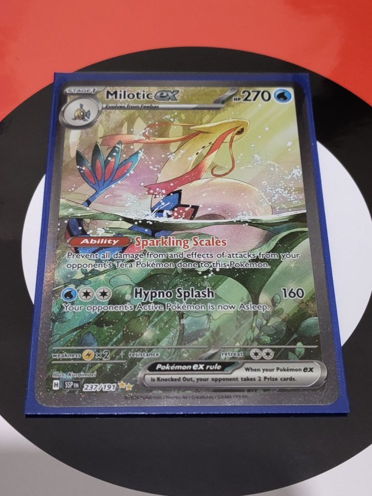 A "Milotic EX" Pokémon card in a card protector