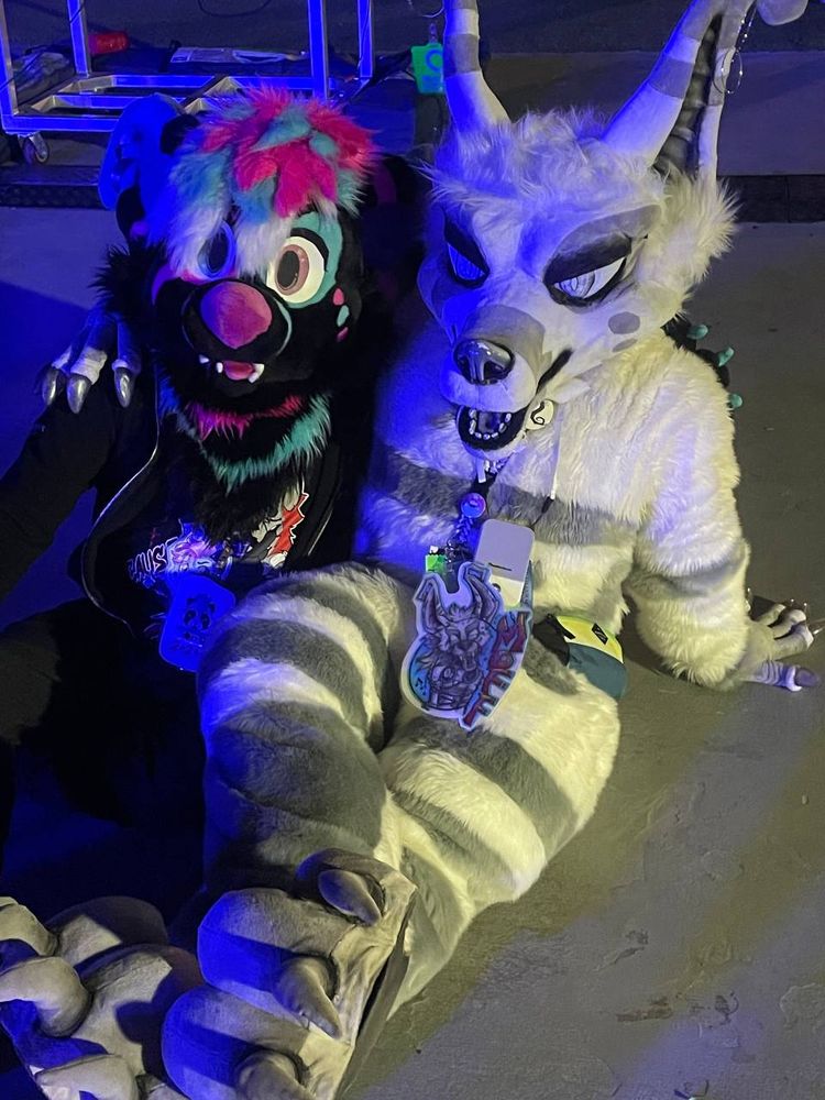 Nikoli the Crux and Moff the Crux sitting with each other and relaxing.