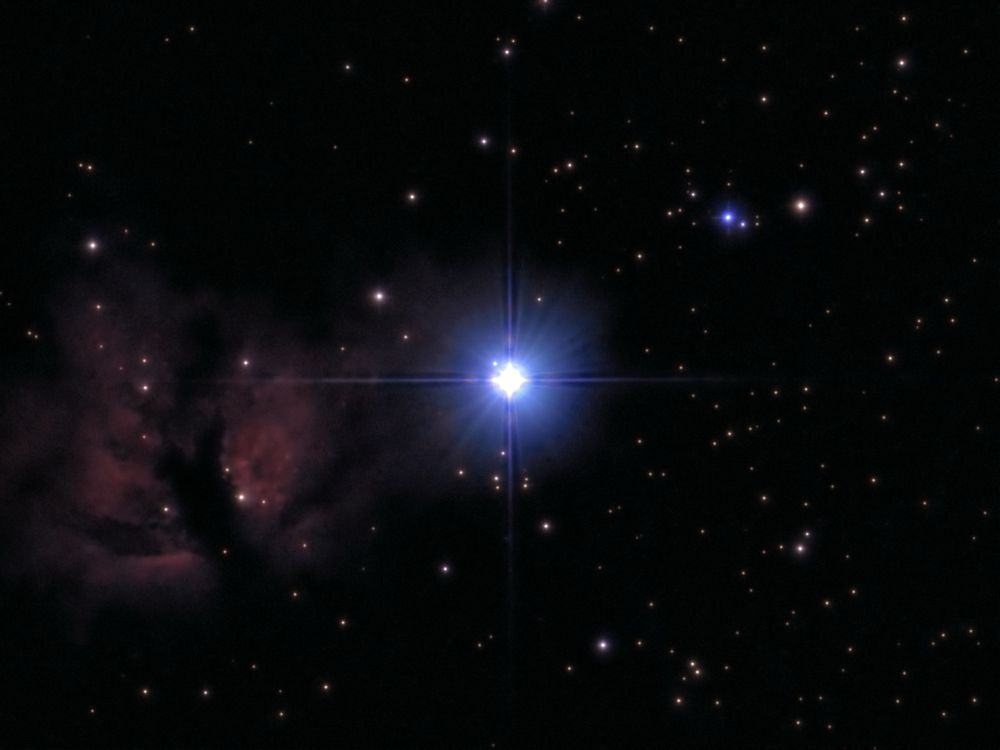 The star Alnitak with the Flame nebula - telescope processed image. Alnitak, at the eastern end of Orion's Belt, is a triple-star system with a hot, blue supergiant that's the brightest O-type star in the sky.