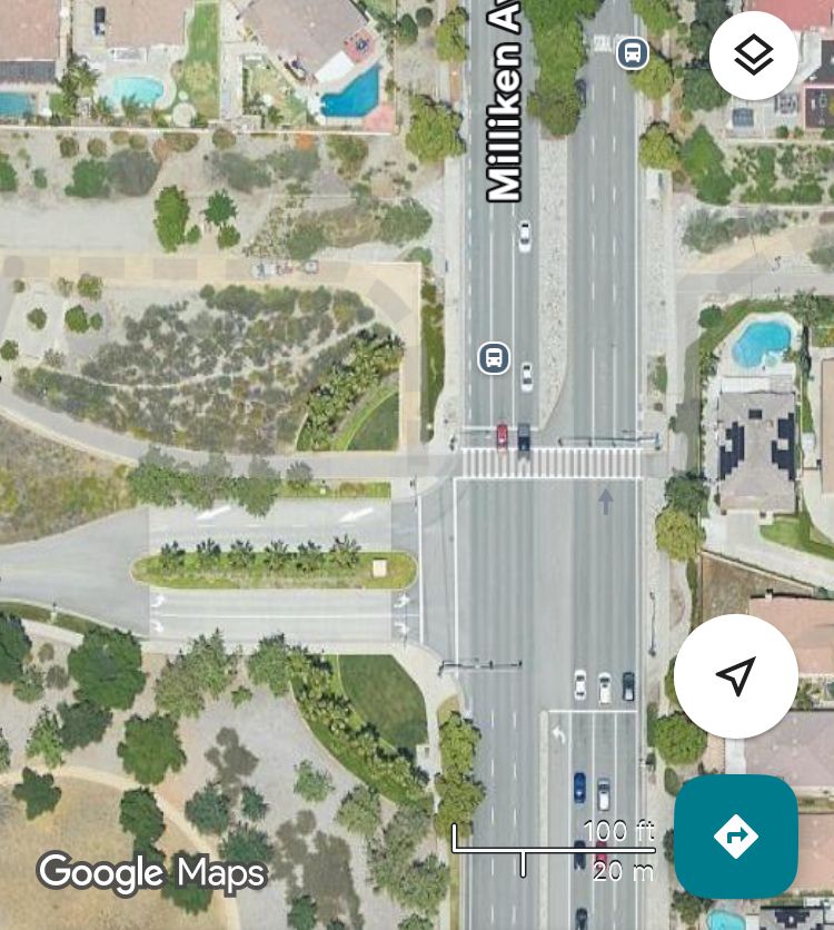 Satellite view of intersection of 6 lane stroad (Milliken) and Central Park exit with zebra crosswalk 