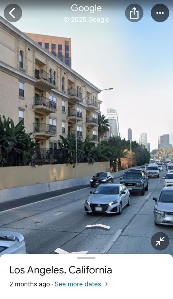Google street view of I-110 passing just feet from multistory apartment buildings 