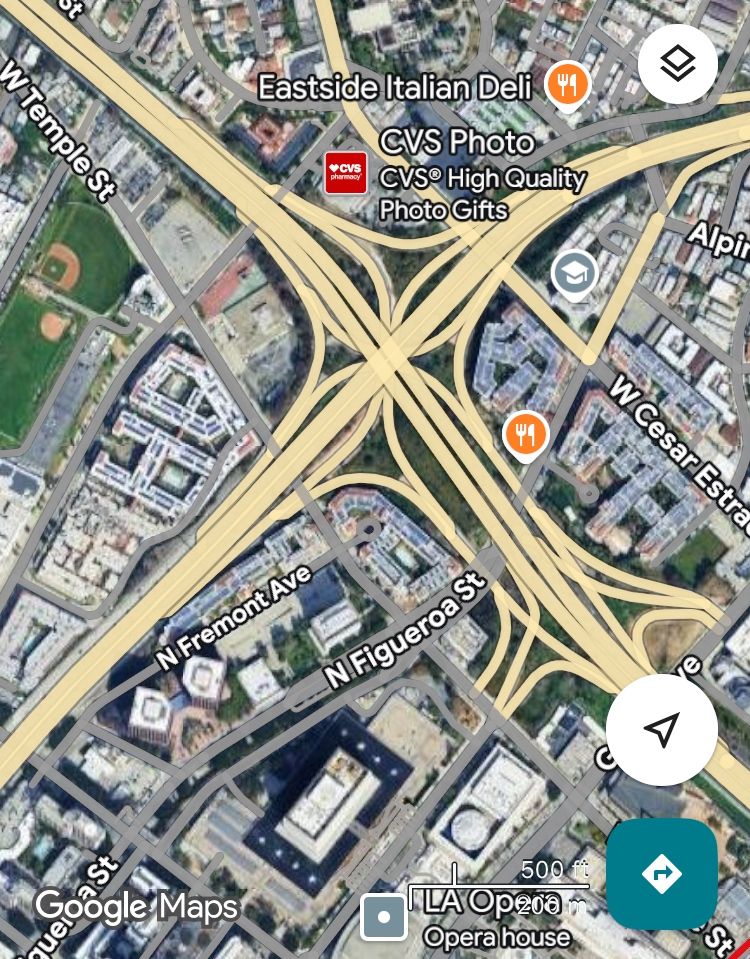 Satellite map view of one of the busiest freeway interchanges in the USA, where I-110 meets CA-101. Tall apartments are jammed into the land abutting 3 of the 4 corners of the interchange 