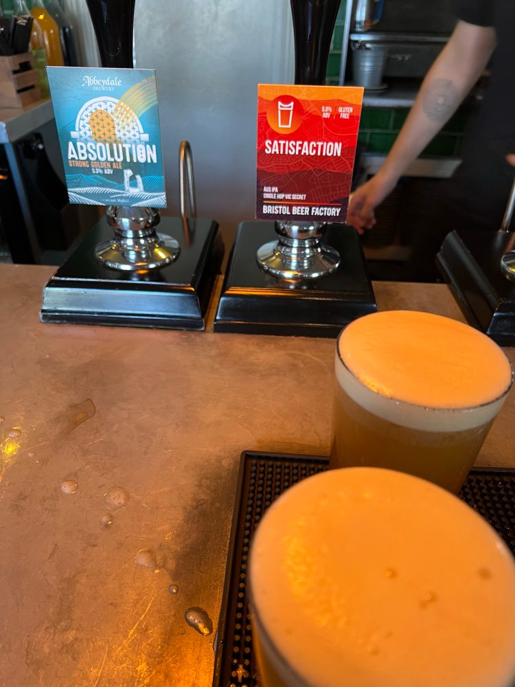 Bar, with two hand pulls Abbeydale brewery and Bristol Beer Factory, with top of two pints in the foreground 