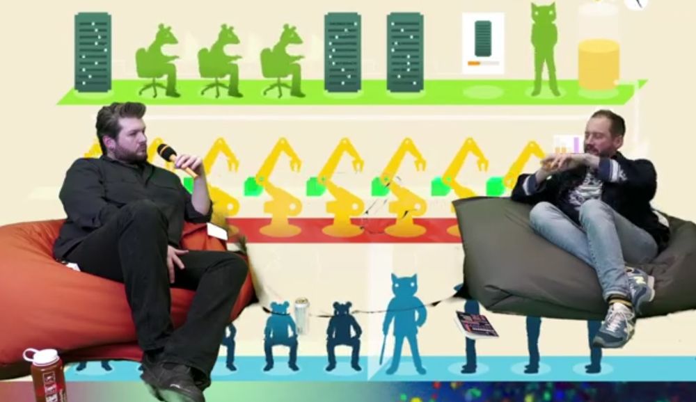 Me and Michael Dieter chatting about cyberbosses at CDI-TV in front of To Build A Better Mousetrap by Molleindustria