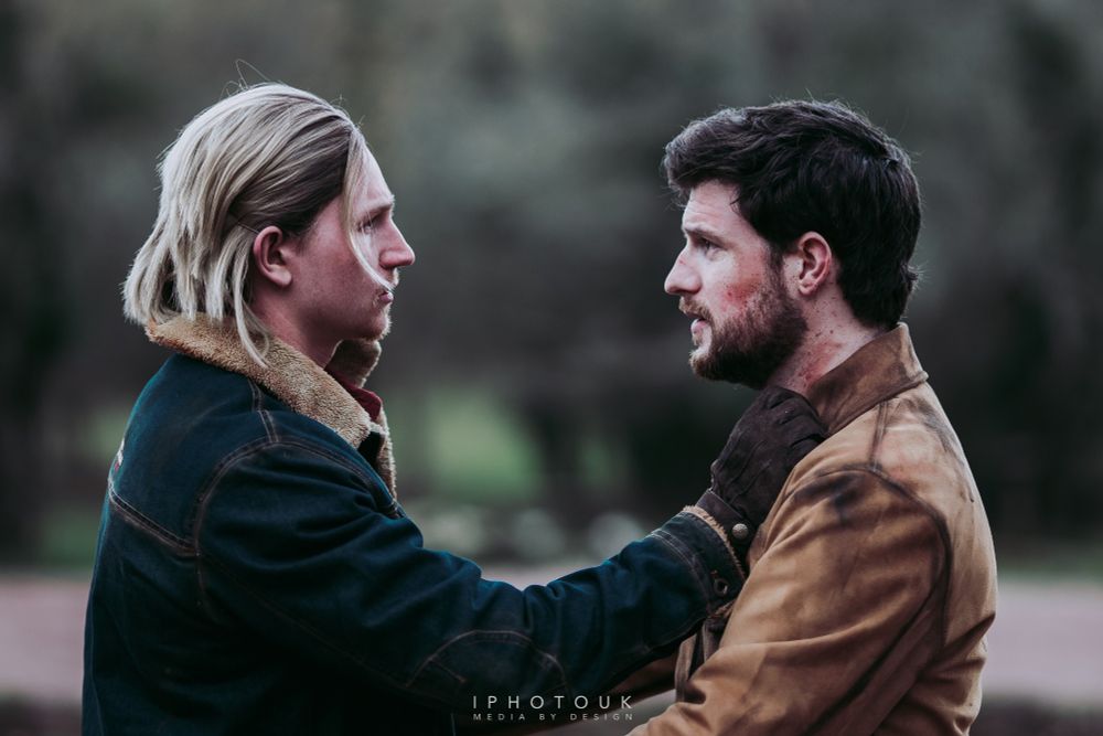Troy cosplaying Tommy Miller and Ben cosplaying Joel Miller. They have found each other again and are about to embrace for the first time in years. Two brothers lost who have found each other.