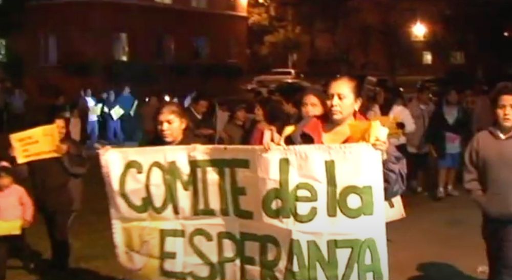 Demonstrators holding a sign that says "Comite de la Esperanza."