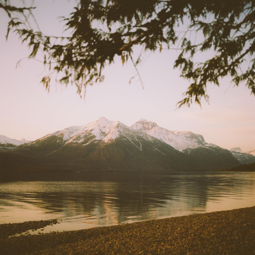 A mountain behind Lake Mcdonald in Glacier National Park at sunset. 