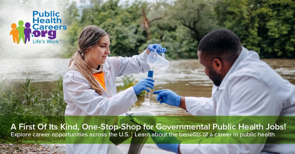 Two scientists from Public Health Careers.org conduct water quality testing by a river, pouring a sample into a flask.