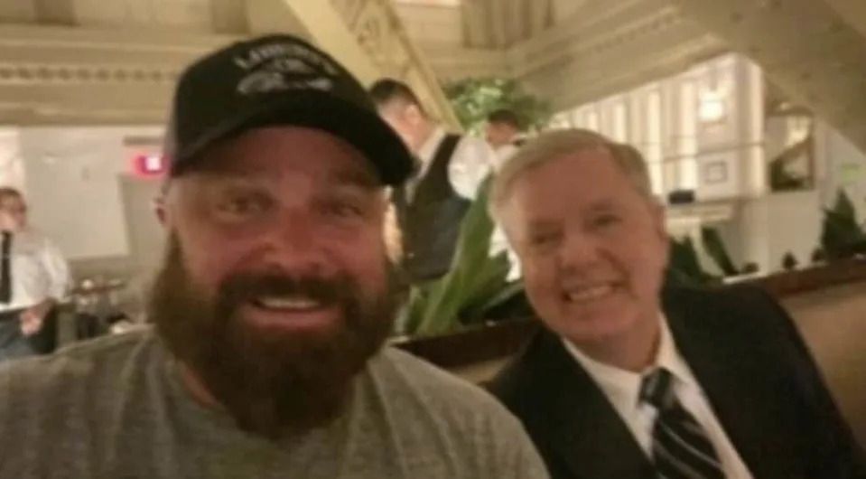 The photo, which has made its rounds on Twitter, shows Sen Graham smiling for a photo-op with Joe Biggs, a known member and organizer of Proud Boys, which has been classified as a racist hate group by the Southern Poverty Law Center.