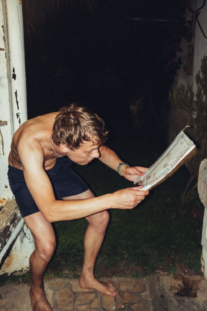 Blowing air with pizza box into the fire 