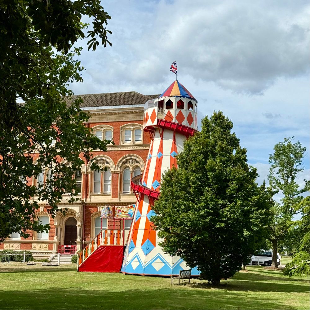 Dulwich College with a fun fair slide in front of it 