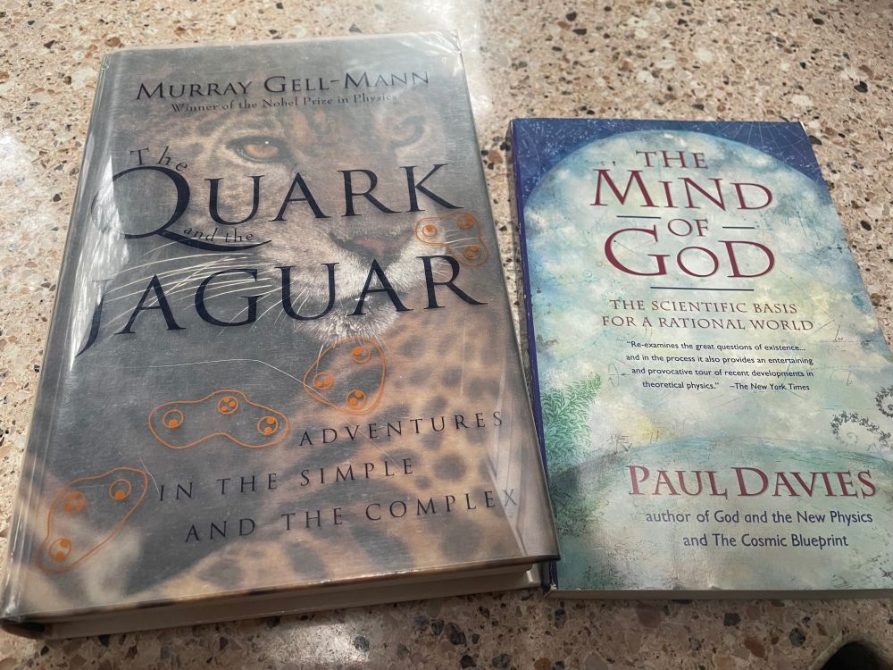 Photograph of two books: Quark Jaguar and The Mind of God, triumphantly purchased at a used bookstore.