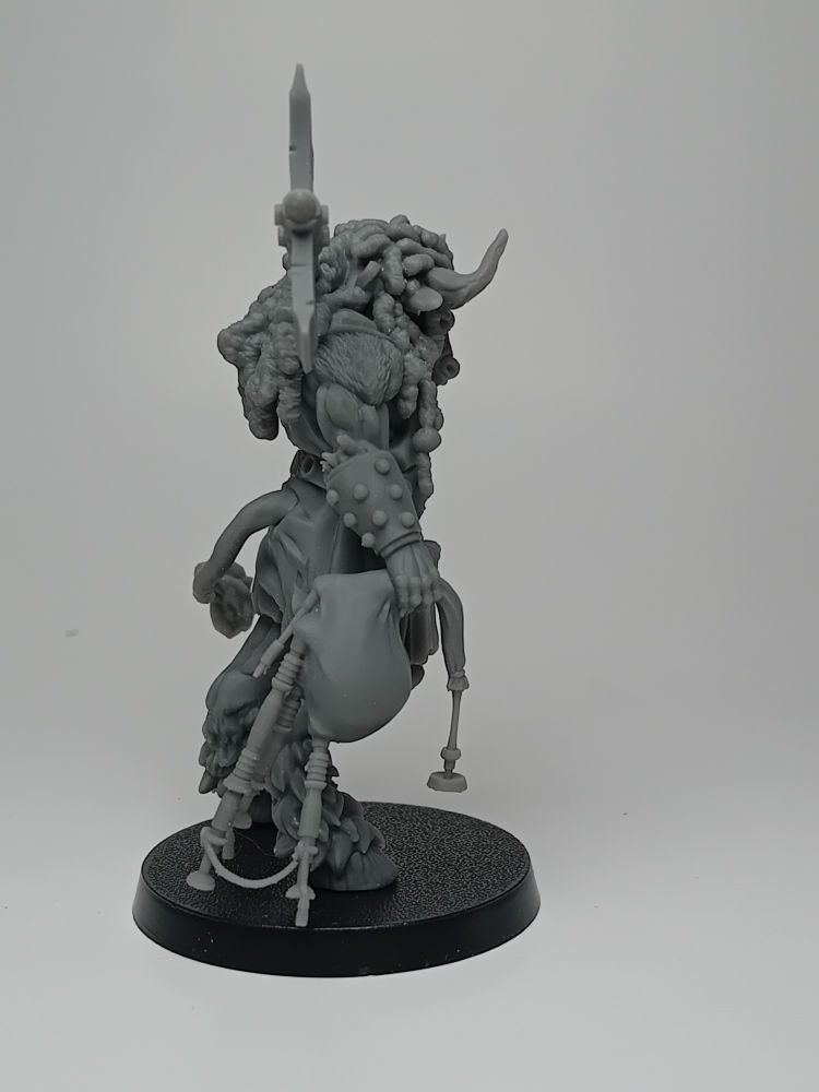 3d printed model of a minotaure. dark grey resin the minotaure is shot from the right angle