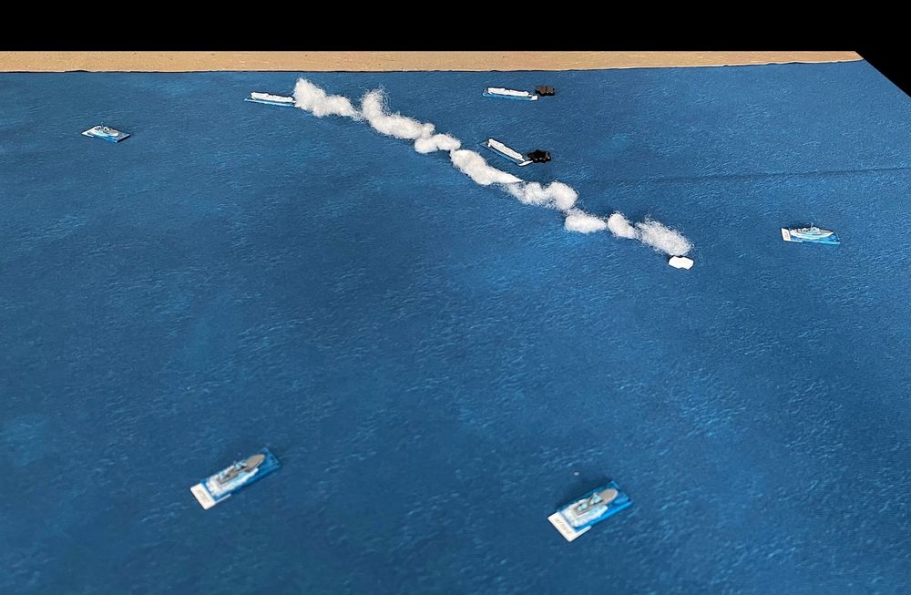 Table with blue cloth representing the oceans and model ships in 1/1250 scale.