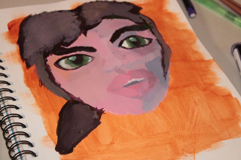 A person with white skin, green eyes, and brown hair with an open mouth.