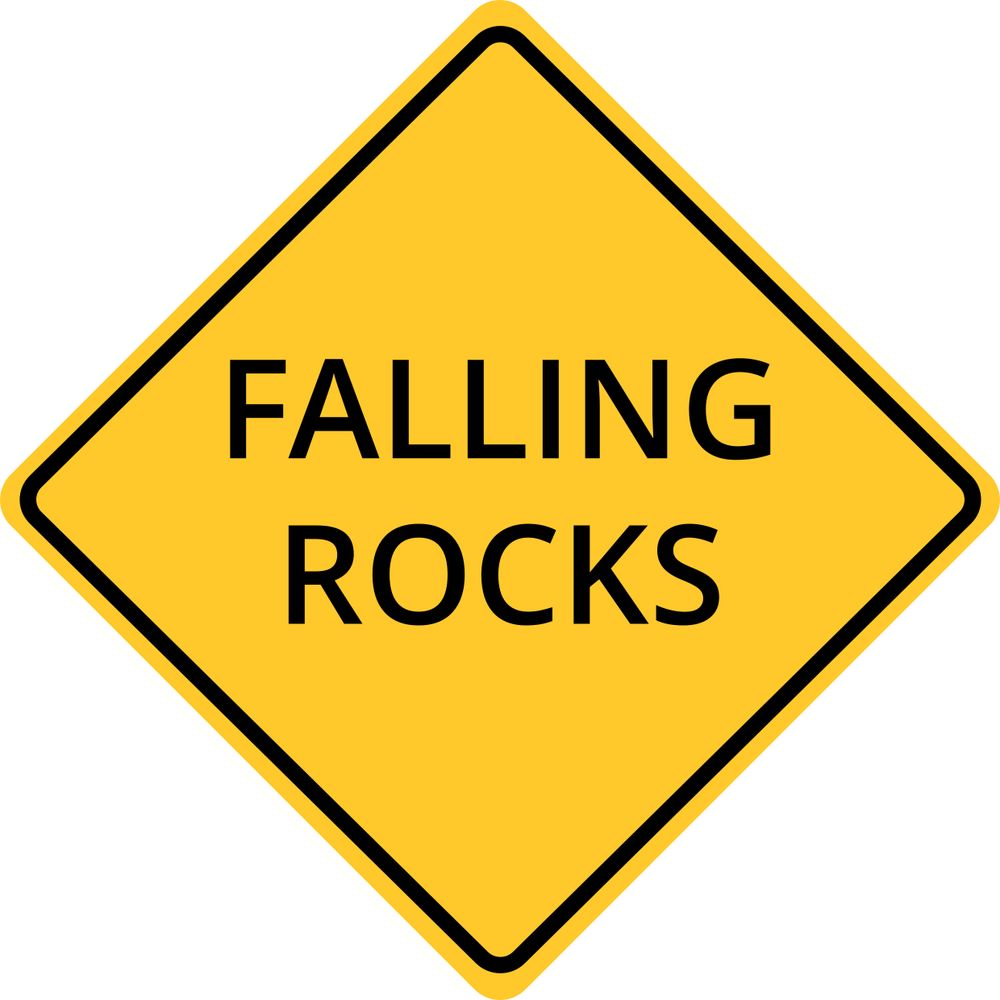 a yellow diamond caution sign that reads falling rocks