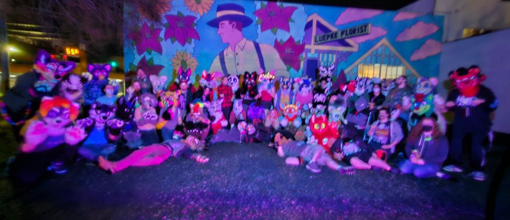A blurry group picture of lots of furries!