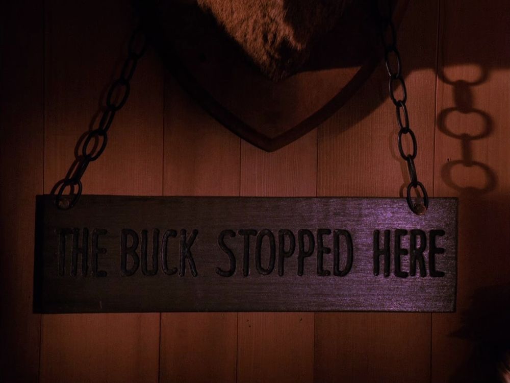 ‘The Buck Stopped Here’, a sign posted in Sheriff Truman’s office. Twin Peaks S02E02 - Coma.