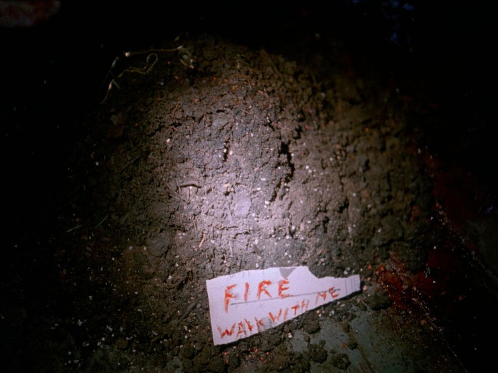 A half-heart necklace on a mound of dirt at the rail-car crime scene. A scrap of paper with the words FIRE WALK WITH ME scrawled on it. Twin Peaks S01E01 - Northwest Passage.