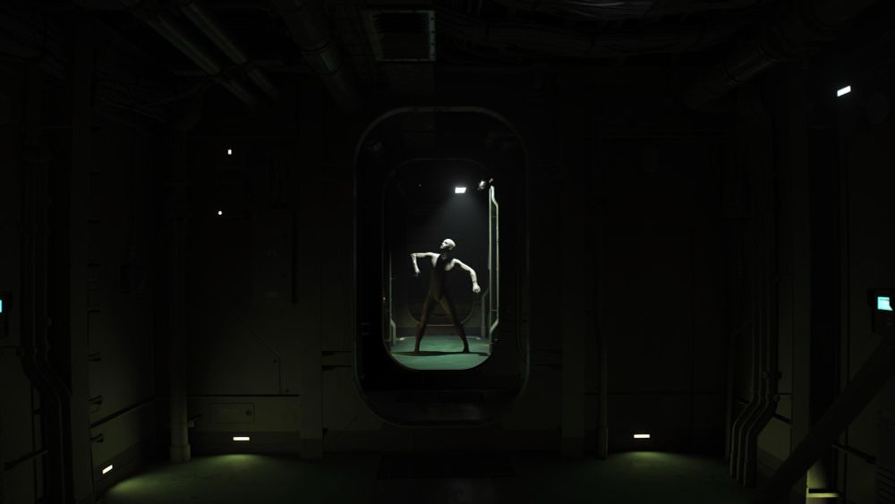 Charlie standing in a dark hallway 