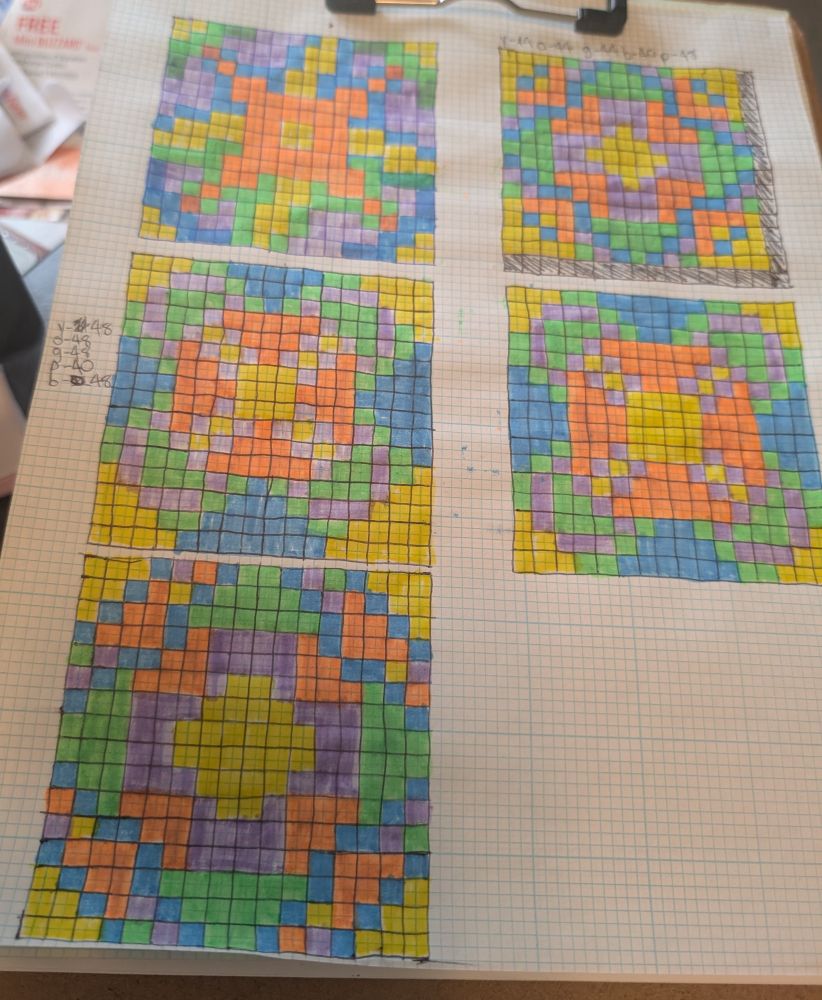 Grid paper with different patterns colored on it. 
The very bottom one is going to be the used design. Maybe I'll find a use for the other designs in another project.