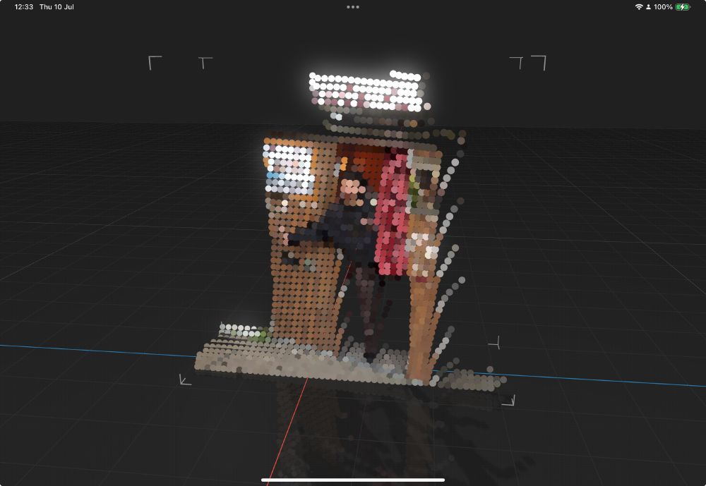 Recorded 3D point cloud recording of a woman in a photo booth with reduced point count and rendered as circles.