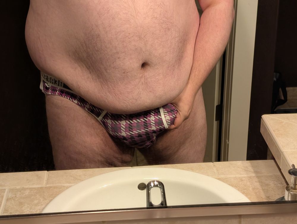Tano in a jock, grabbing his fat pad