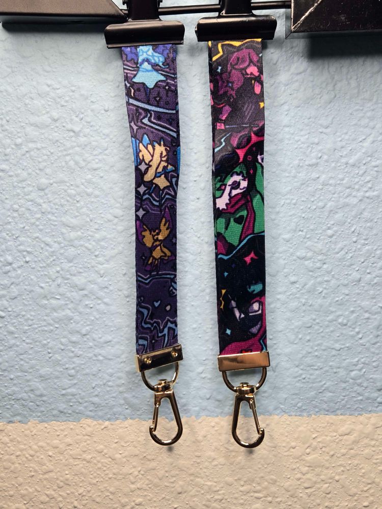 Two lanyards one has fairys on it the other the deltarune main cast