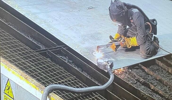 A photograph of an apprentice welding steel for the new HMS Sheffield