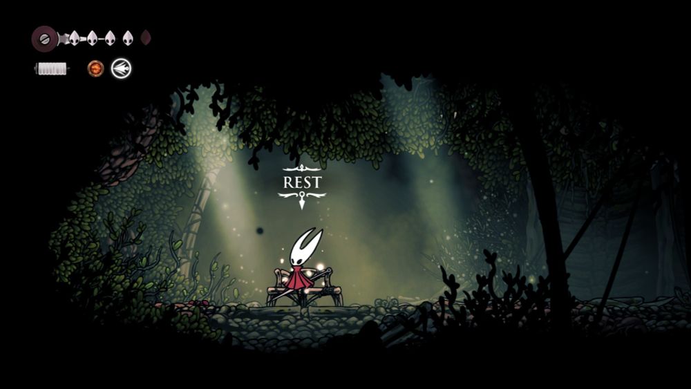 Hornet at the bench in Hunter's March with the REST prompt above it. (Hollow Knight: Silksong, 2025)