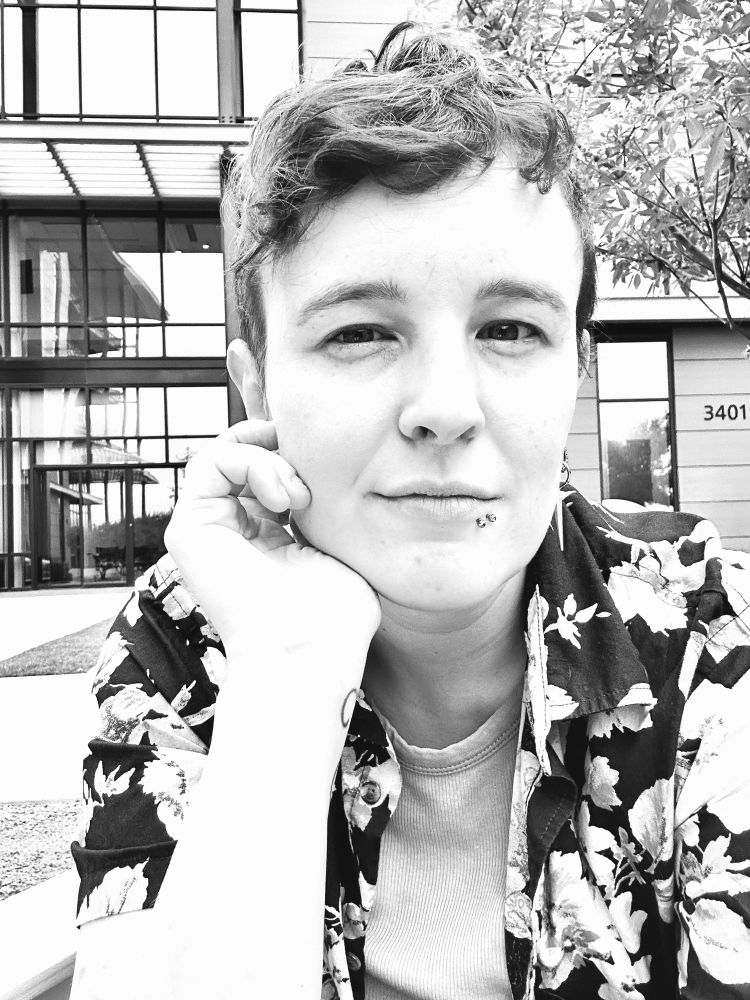 Black and white of me outside in a flowery short sleeve shirt.