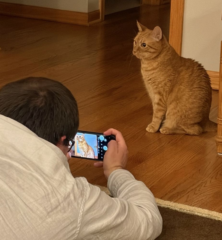Me, on the floor, taking a photo of the cat sitting nearby