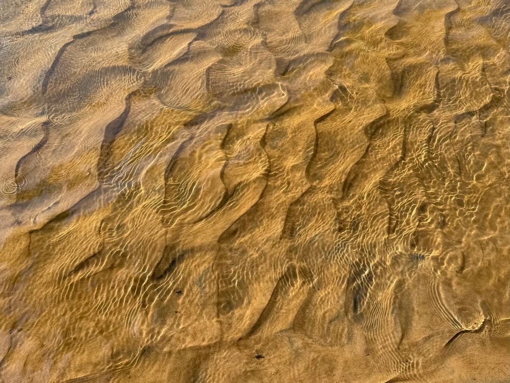Patterns in the sand and water of the Rivanna River. 