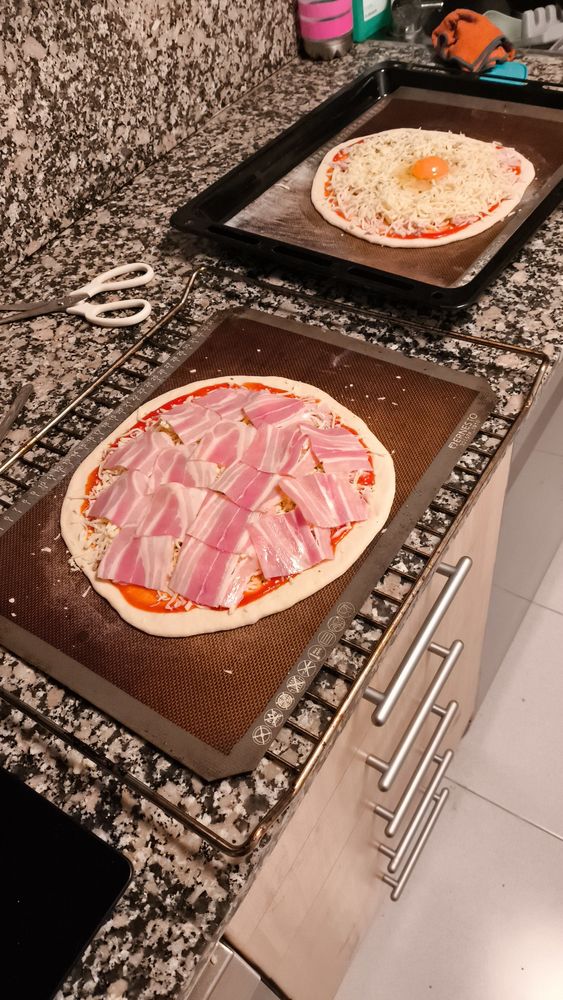 Dos pizzas preparadas para entrar al horno.