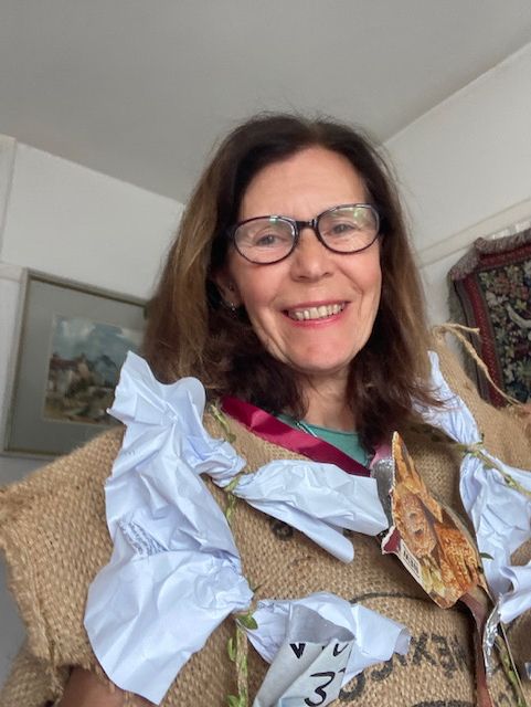 smiling woman (Susie) wearing coat made of waste
