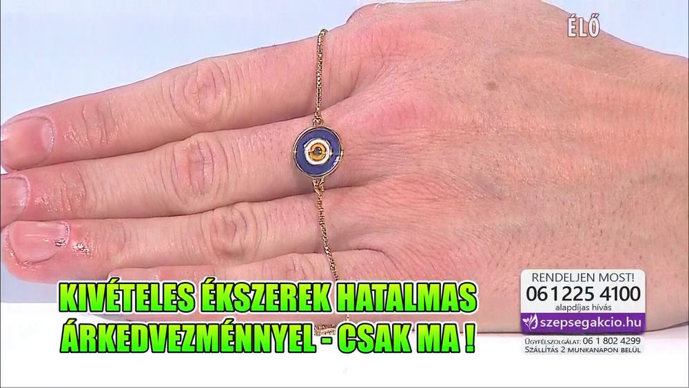 IPTV screencap of Hungarian jewelry teleshopping program "Szépségakció" (translates to Beauty Sale). The presenter Ákos is showing off a piece of dubious jewelry that looks like an eye. On the bottom, in a green-to-yellow Impact font is "Exceptional jewels with a giant sale - only today!"
