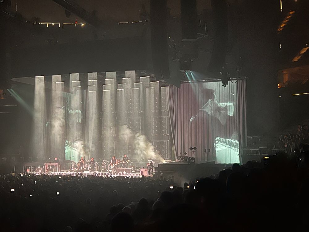 Nine Inch Nails perform on the main stage at Xcel Energy Center in pillars of white light.