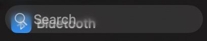 a search bar with the bluetooth settings icon under it, obscuring the spyglass icon.  the text is also obscured by the half-blurred ‘bluetooth’ text under it