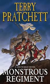 Cover of Terry Pratchett’s Monstrous regiment featuring women and a troll in Napoleonic era type military costumes pushing a flag into the hill after the iconic image of US soldiers pushing up the Stars and Stripes at Iwo Jima