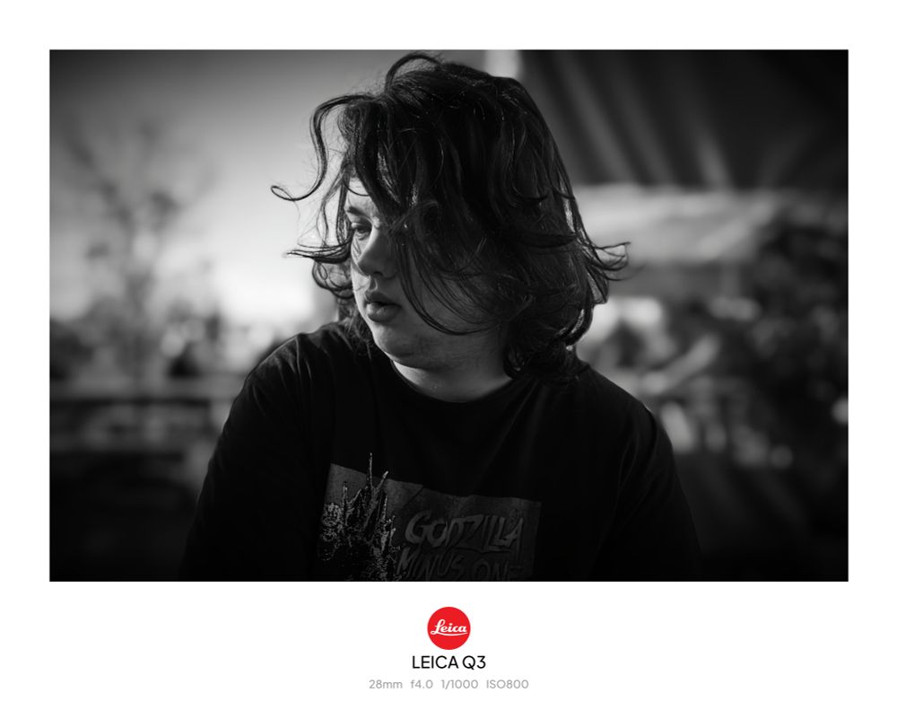 Same young man close up. Face is dark except for right side lit by low winter sun. 